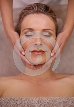 Destressing with a head and neck massage. a woman in a day spa getting a face massage.