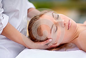 Destressing with a head and neck massage. a young woman enjyoing a massage at the day spa.