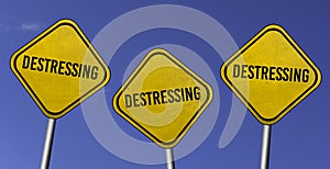 destressing - three yellow signs with blue sky background