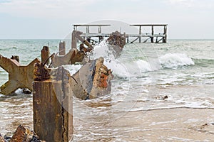 Destroed stone pier, splash wave sea