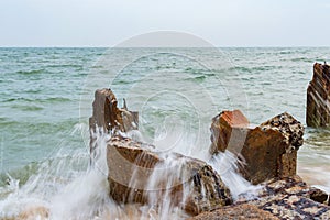 Destroed stone pier, splash wave sea