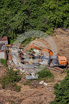 Destroy the construction machines of an old building in the forest