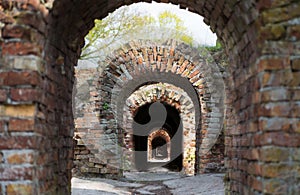 Destroyed brick arch old brickwork corridor long dark corridor under