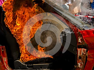 Destroyed car on fire in a fire service show