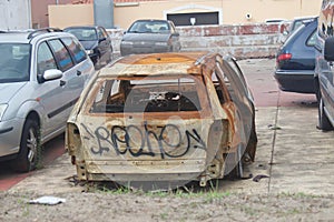 Destroyed car in Portugal, ghetto neighborhood