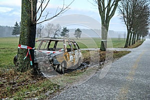 Destroyed car standing by the road