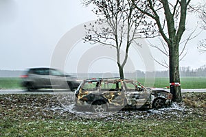 Destroyed car standing by the road