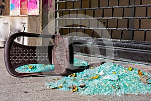 Destroyed chair and shattered glass on a street