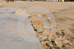Destroyed and covered with sand road on the beach
