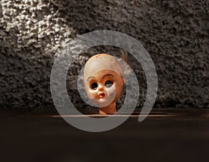 A destroyed and disturbing broken doll with head