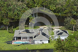 Destroyed house roof by hurricane Ian strong winds in Florida residential area. Natural disaster and its consequences