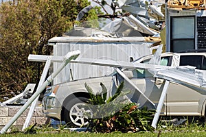 Destroyed by hurricane Ian suburban house and damaged car in Florida mobile home residential area. Consequences of