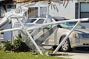 Destroyed by hurricane Ian suburban house and damaged car in Florida mobile home residential area. Consequences of