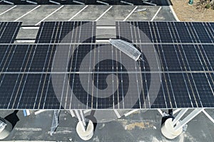 Destroyed by hurricane wind solar panels installed over parking lot canopy shade for parked cars for effective