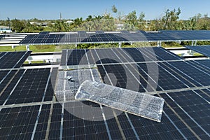 Destroyed by hurricane wind solar panels installed over parking lot canopy shade for parked cars for effective