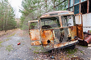 Destroyed old rusty bus at Factory in Pripyat ghost city, Chernobyl Nuclear Power Plant Zone of exclusion and alienation