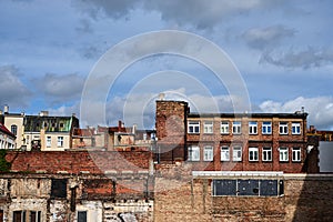 destroyed red brick wall and old tenement houses in Poznan city