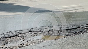 Destroyed road while cars driving over