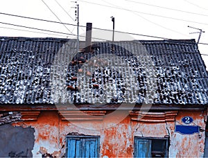 Destroyed roof of the abandoned house architecture background