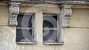 Destroyed windows in the attic of the tenement house.