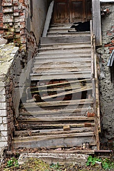 Destroyed wooden staircase with broken railings.