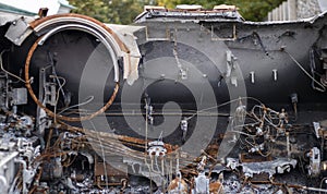 Destroyed, wrecked and burned T-72 tank with a designation V on it. Russian-Ukrainian conflict in 2022. Destroyed Russian military