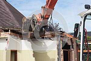 Destruction of a building by a caterpillar crane