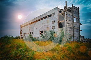 The destruction of a multi-story building. Shot on a background of blue sky and sun