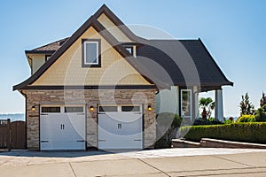 Detached big family house with double size garage. Residential house with concrete driveway. Custom built luxury house