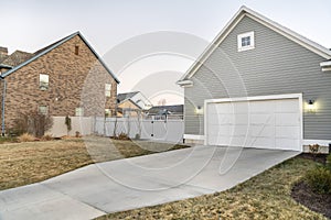 Detached garage with closed white door and gable design exterior