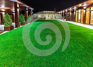 Detached house at night view from outside the rear courtyard.