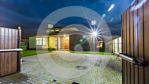 Detached luxury house at night - view from outside.