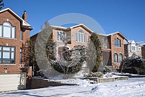 Detached middle class single family houses on a sunny day in winter