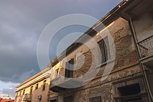 Detail of an abandoned building in cloudy landscape