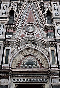 Detail, above a very elaborate door, of the wall of the cathedral Santa Maria del Fiore in Florence.