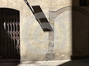 Abstract shadow patterns on a historic building wall