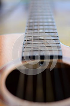 Detail of acoustic guitar with shallow depth of field