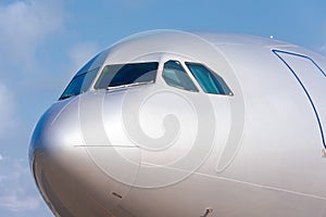 Detail of airplane nose with cockpit window