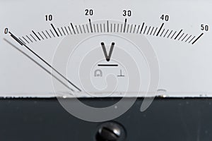 Detail of an analog voltmeter, pointer scale