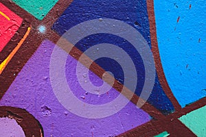 Detail of an anonymous street graffiti with many colors, cheerful urban background
