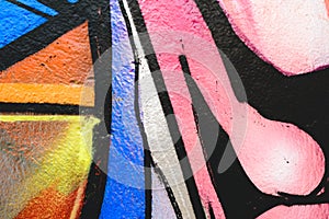 Detail of an anonymous street graffiti with many colors, cheerful urban background