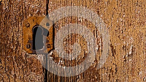 detail of antique lock on brown wooden door