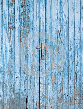 detail of an antique wooden door painted blue