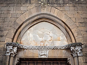 Detail of the arch of the imposing 13th century portal of the church of San Francesco in Pienza, Italy