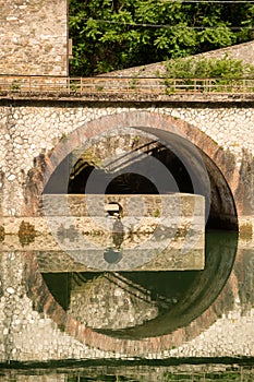 Detail of arched stonework along the banks of the Serchio river