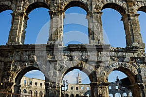 The detail of Arena Pula with cloudy sky in the background