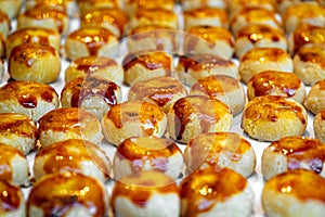 Detail of an assortment of sweet golden toasted burnt sugar panellet cookies on a tray fresh from the gourmet artisan oven. photo