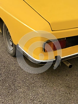 Detail from the back of a vintage yellow car