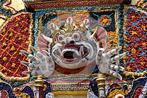 Detail Bade cremation tower with traditional balinese sculptures of demons and flowers on central street in Ubud, Island Bali,