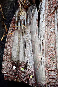 Detail of balinese wooden sculpture, hand and skirt